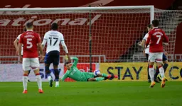 Simon Sluga spreads himself to block a shot