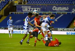 Jordan Clark and Danny Hylton in a real scrap for the ball