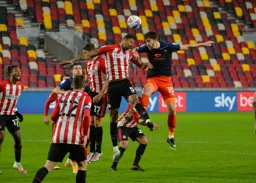 Tom Lockyer and Ethan Pinnock go for a header