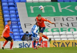 A firm defensive header by Tom Lockyer clears the ball
