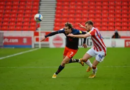 Harry Cornick goes past former Hatter Rhys Norrington-Davies