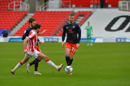 James Bree is about to be tackled by Joe Allen