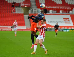 Elijah Adebayo appears to be getting a lift up from Rhys Norrington-Davies