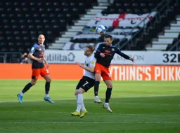 Jordan Clark beats Kamil Jozwiak to win a header