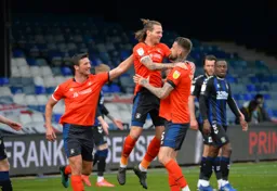 Matt Pearson and Sonny Bradley celebrate with Glen Rea after his goal