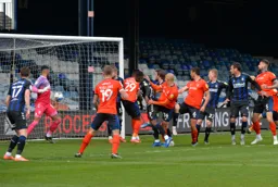 Kal Naismith`s header is kept out but Glen Rea following up will put the ball into the net