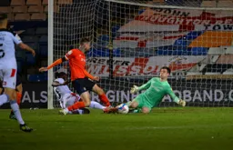 Sonny Bradley and Simon Sluga combine to halt this United attack