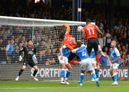 Elijah Adebayo about to open the scoring with a towering header