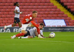 Henri Lansbury misses out to Cauley Woodrow in midfield