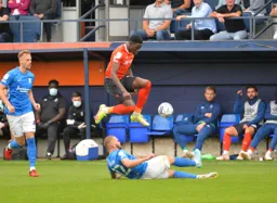 Elijah Adebayo hurdling a challenge from Harlee Dean