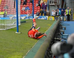 Luke Berry trips over an atmosphere microphone while celebrating his late leveller