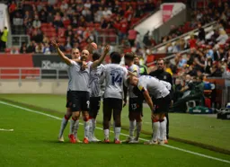 Danny Hylton celebrates with the team after levelling the game late on