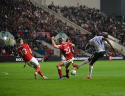 Elijah Adebayo has a dig from the edge of the box