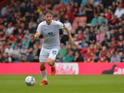 Tom Lockyer strides forward with the ball
