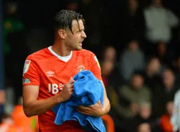 Harry Cornick dries off the ball with a towel