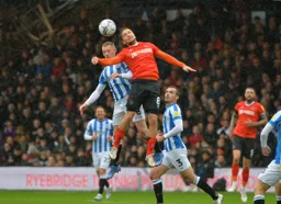 Luke Berry battling in the air with Lewis O'Brien
