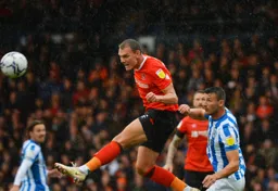 Kal Naismith wins an aerial battle against former Hatter Matty Pearson