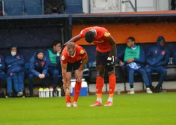 Elijah Adebayo checking on James Bree after receiving a knock