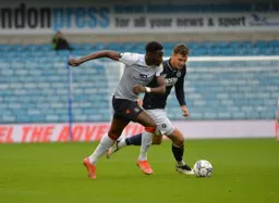 Elijah Adebayo drives forward with the ball