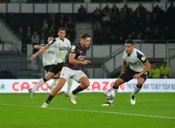 Harry Cornick trying to get round the outside of former Hatter Curtis Davies