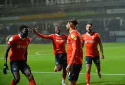 Players run to celebrate with Harry Cornick