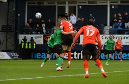 Sonny Bradley gets a header away at goal
