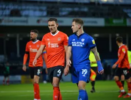 Kal Naismith walking off at halftime talking to former Hatter James Collins
