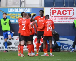 The team celebrating with Elijah Adebayo after he opens the scoring