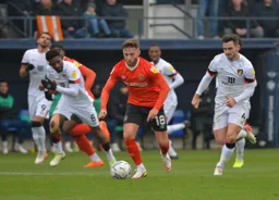 Jordan Clark drives forward with the ball away from Lewis Cook and Jefferson Lerma