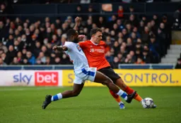 Kal Naismith plays a ball down the line while under pressure