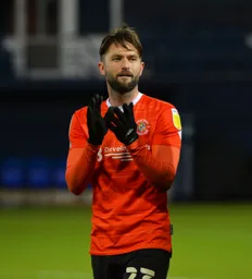 Henri Lansbury applauding the fans after another hard battling display in midfield