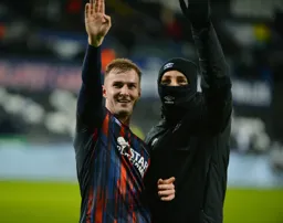 James Bree and Tom Lockyer wave to the travelling fans who came all the way to Wales
