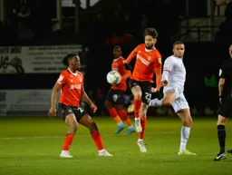 Future Hatter Carlton Morris battles with Henri Lansbury as Peter Kioso watches on