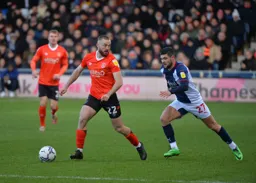 Allan Campbell keeping the ball away from Alex Mowatt