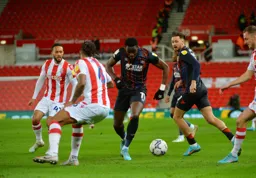 Elijah Adebayo driving through the Stoke defence