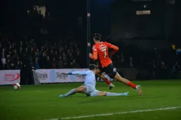 Harry Cornick slides the ball past Keeper Kepa