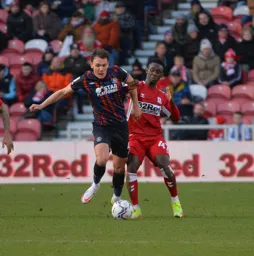 Kal Naismith battling to bring the ball out of defence