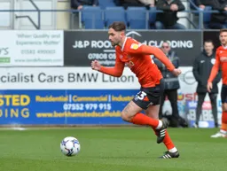 Henri Lansbury drives forward with the ball
