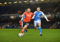 Allan Campbell driving forward with the ball under pressure