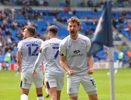 Tom Lockyer gees up the crowd after the goal