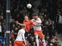 Kal Naismith and Sonny Bradley (partially obscured) challenging for the aerial ball