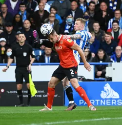James Bree gets his head to the ball under an intense challenge from Lewis O'Brien