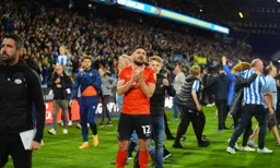 Robert Snodgrass is broken up as Huddersfield fans storm the pitch to celebrate