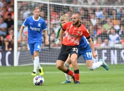 Allan Campbell brings the ball forward with Jordan James snapping away at his heels