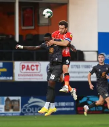 Tom Lockyer wins a header against Chanks Zimba