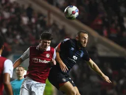 Allan Campbell goes for the ball with his eyes closed