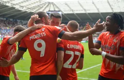 Carlton Morris celebrates scoring the Town`s second goal. Gabriel Osho looks pleased about it