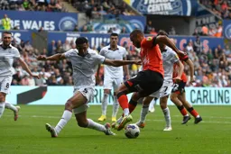 Carlton Morris is stopped in his tracks by Ben Cabango