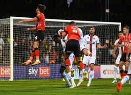Tom Lockyer and Carlton Morris cannot make contact with the ball