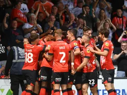 Carlton Morris is mobbed by his colleagues after scoring the Town`s goal